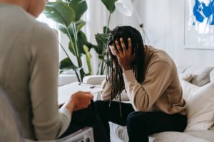 Black man in some stress at therapy, where he may learn that suffering is optional